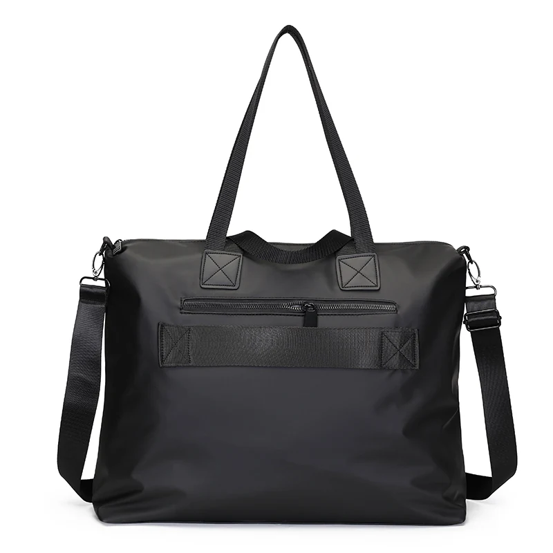 Back of the Nordin sleeve bag showing the wide luggage sleeve strap and a zip pocket